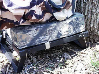 The Ultimate Seat by Sportsman Comfort Products ( both legs extended with Hunter sitting on it ).